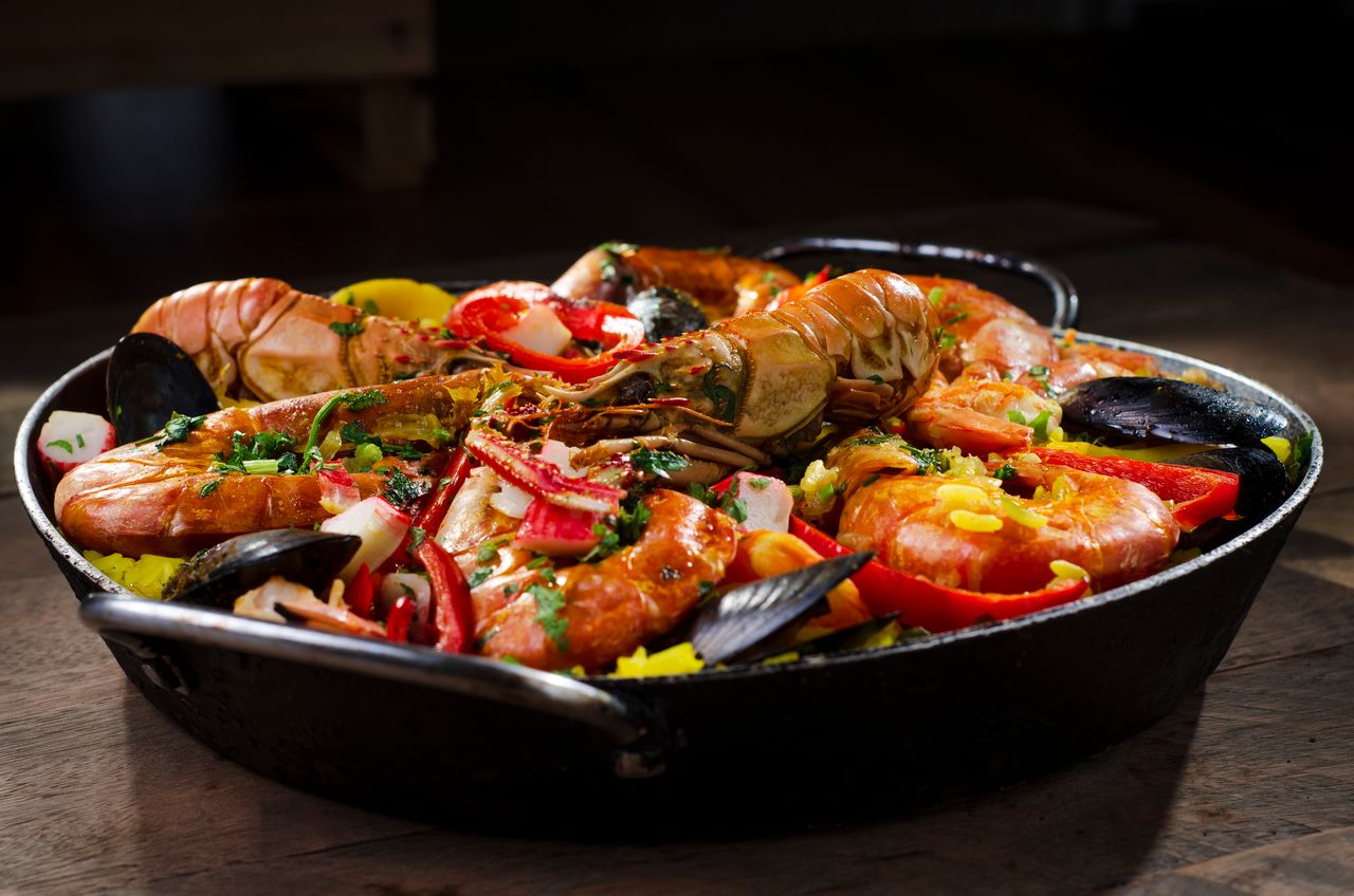 Mouth-watering seafood paella with shrimp, mussels, rice, and peppers.